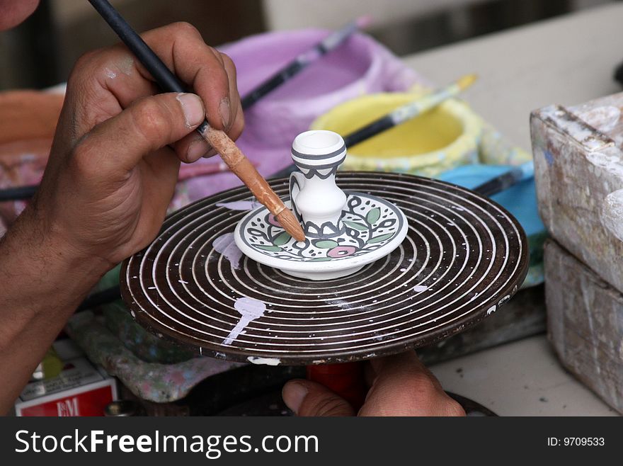 Arab Artisan Hand-Paints a Traditional Souvenir in Hebron. Arab Artisan Hand-Paints a Traditional Souvenir in Hebron