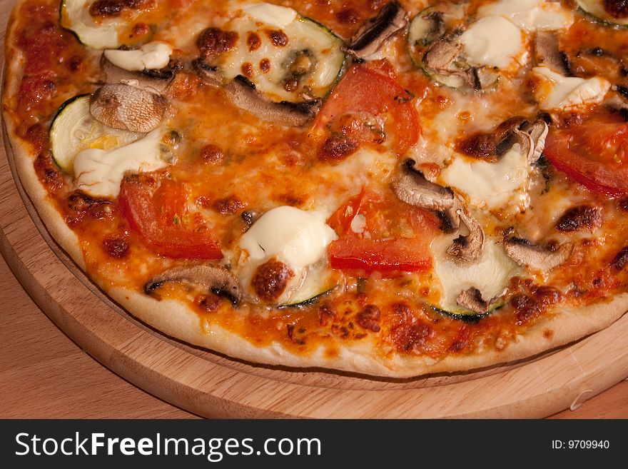 Freshly baked pizza from the furnace with vegetables. Freshly baked pizza from the furnace with vegetables