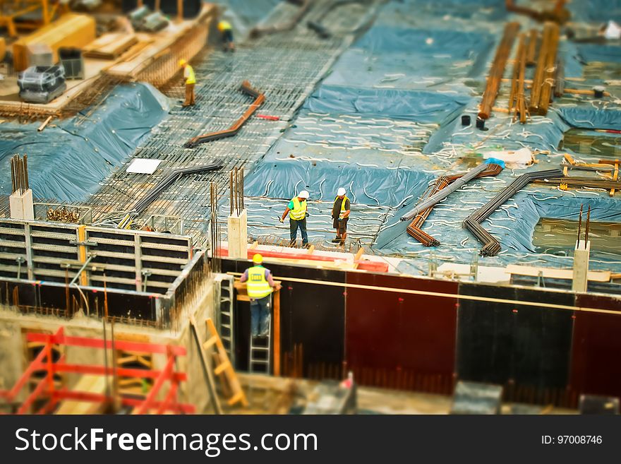 Man In Yellow Safety Vest Climbing On Ladder