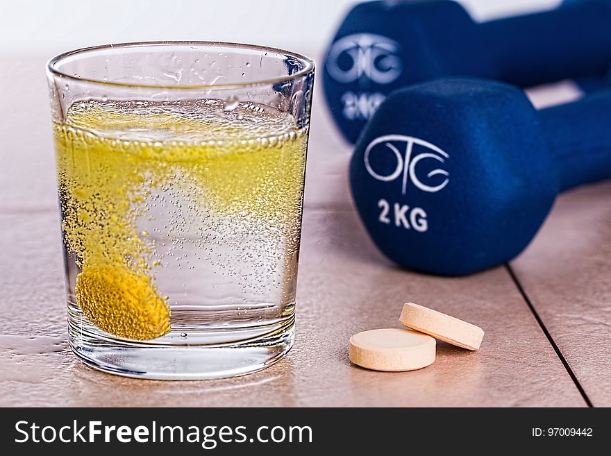 Melting Yellow Tablet In The Filled Drinking Glass