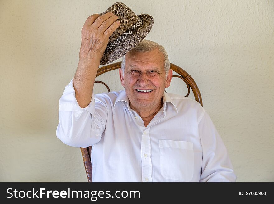 Elderly man saluting with his hat above the head. Elderly man saluting with his hat above the head