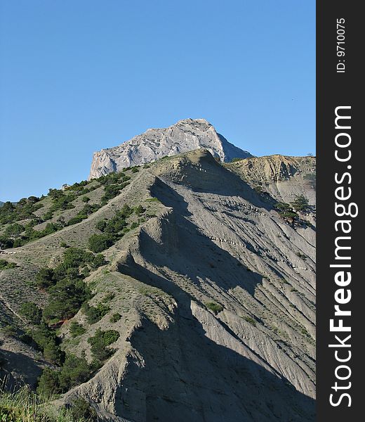 Mountain range passing in blue sky. Crimea.