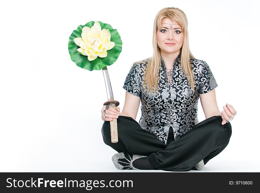 Woman with katana meditating in lotus pose, isolated on white background