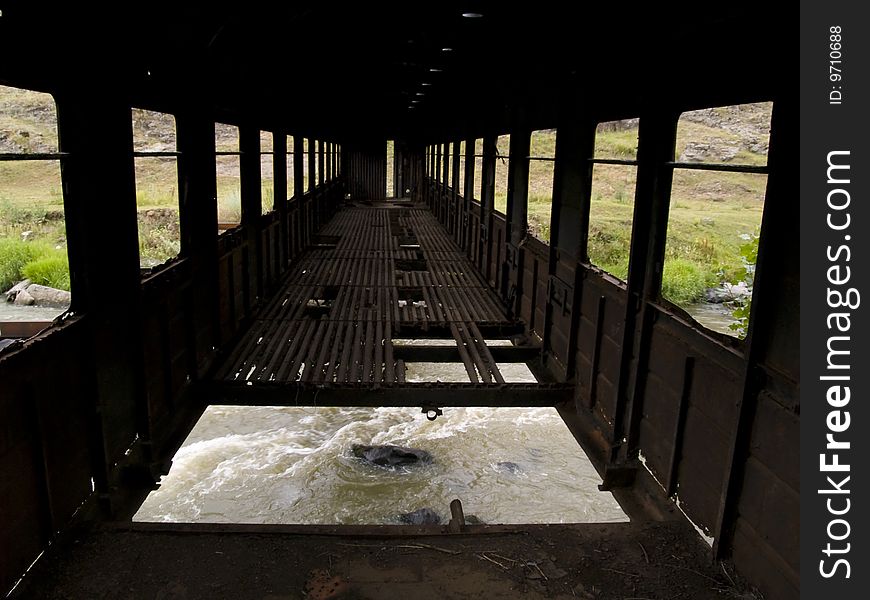 Big hole in the old bridge. In down rapid mountain river. Big hole in the old bridge. In down rapid mountain river