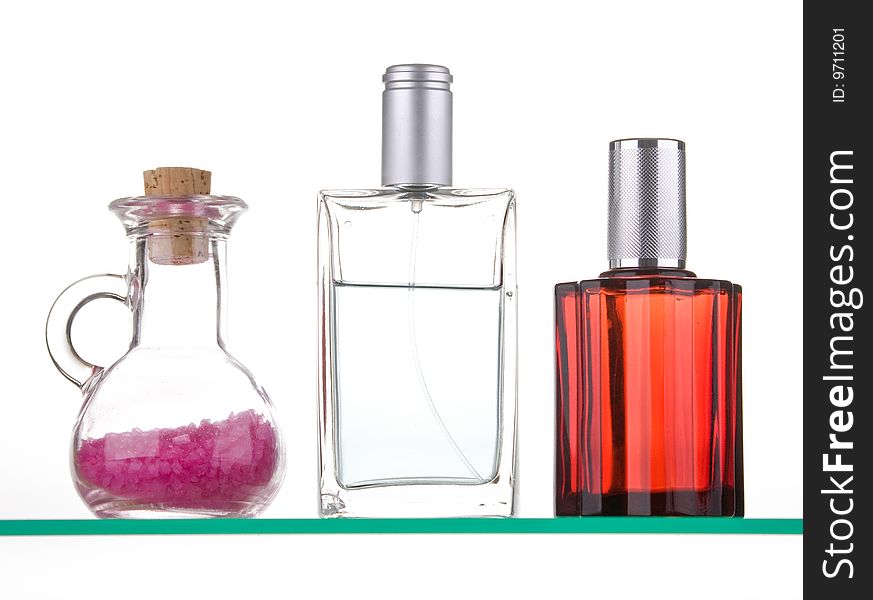 Perfume with decoration on a glass shelf. Perfume with decoration on a glass shelf