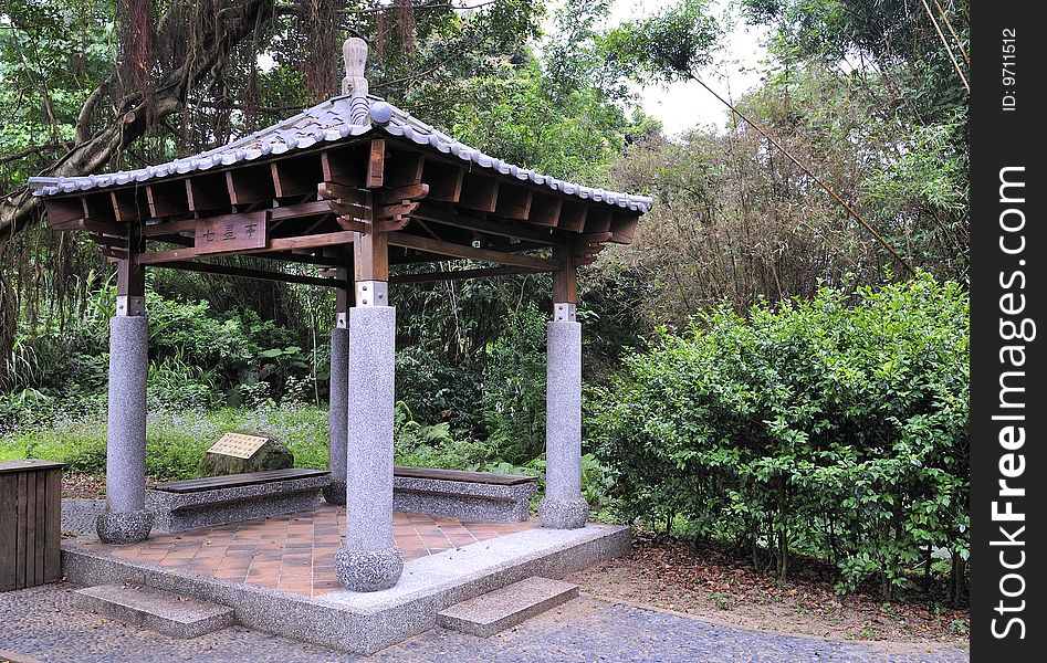 A square-shaped asian pavilion in the forest