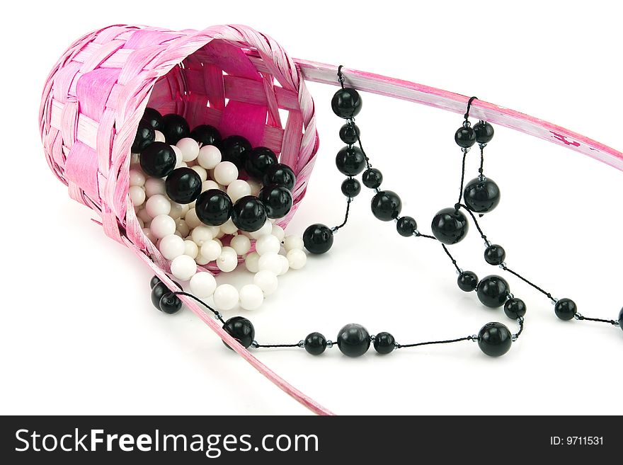 Colored Pearl Beads In Pink Wicker Basket Isolated