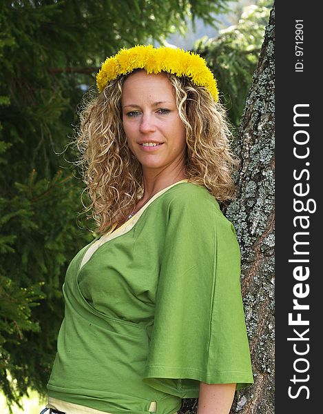 Curly girl with dandelion chain on head