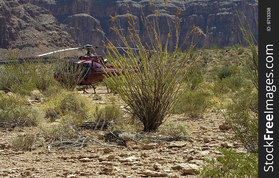 Red helicopter landed in a desert. Red helicopter landed in a desert