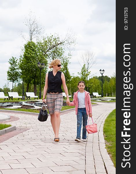 Mother and the daughter walk on a path in park. Mother and the daughter walk on a path in park