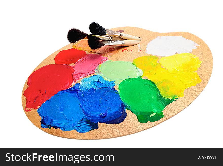 Three paintbrush on the palette with bright acrylic paints. Three paintbrush on the palette with bright acrylic paints