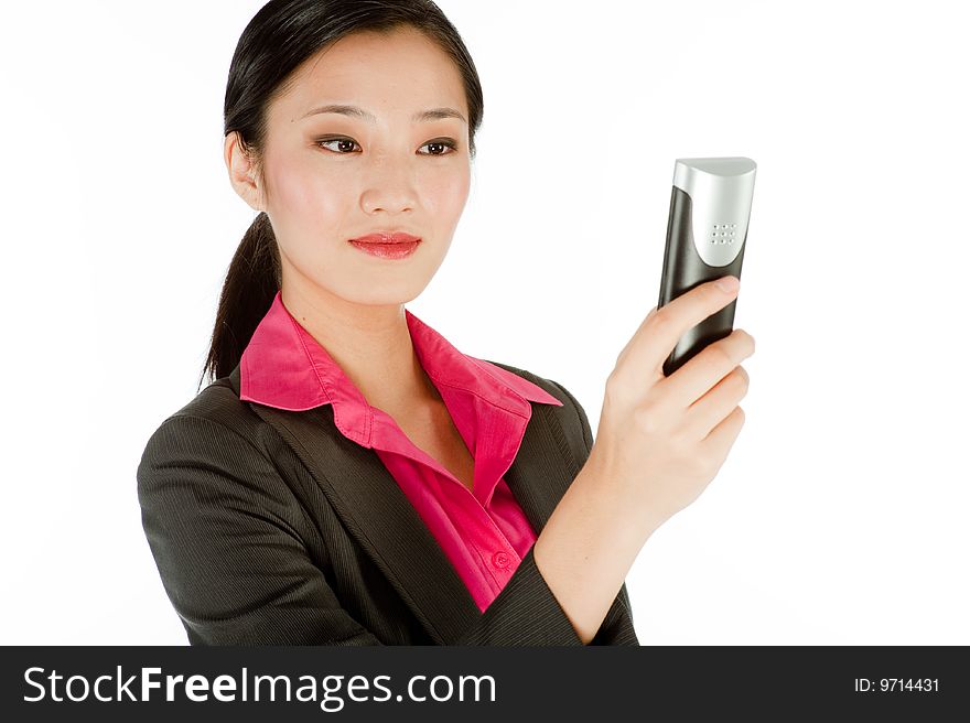 A beautiful businesswoman holidng a mobile phone. A beautiful businesswoman holidng a mobile phone