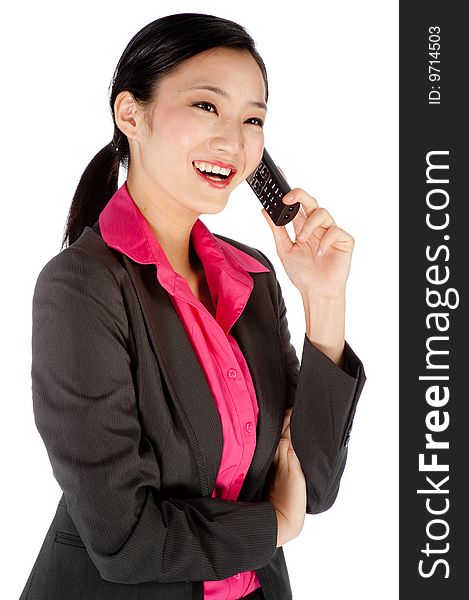 An attractive businesswoman using a phone. An attractive businesswoman using a phone