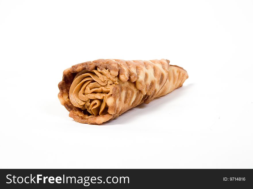Wafer tubule, with a cream stuffing, on a white background
