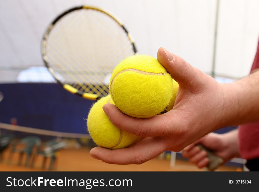 Man holds three tennis balls in a hand. Man holds three tennis balls in a hand.