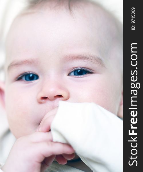 Portrait of a beautiful baby with his hands around your mouth