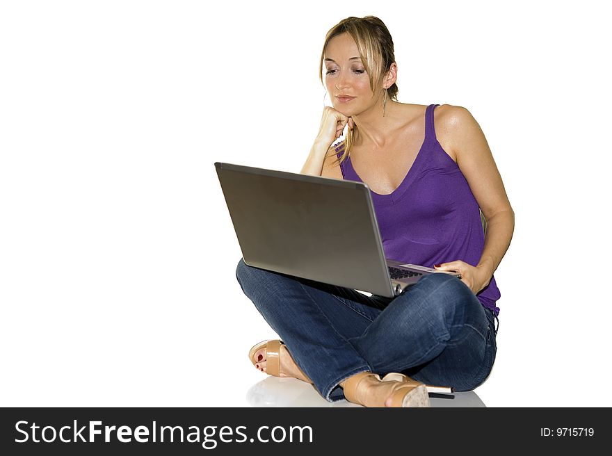 Young attractive woman in tshir blue jeans on professional laptop computer, on white backdrop. Young attractive woman in tshir blue jeans on professional laptop computer, on white backdrop