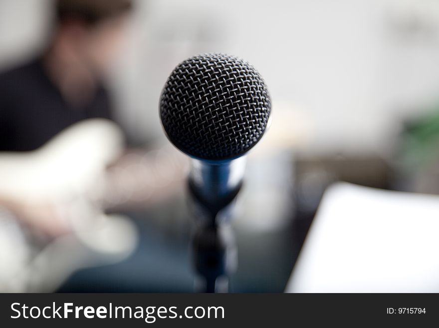 Microphone and guitar with blurred background