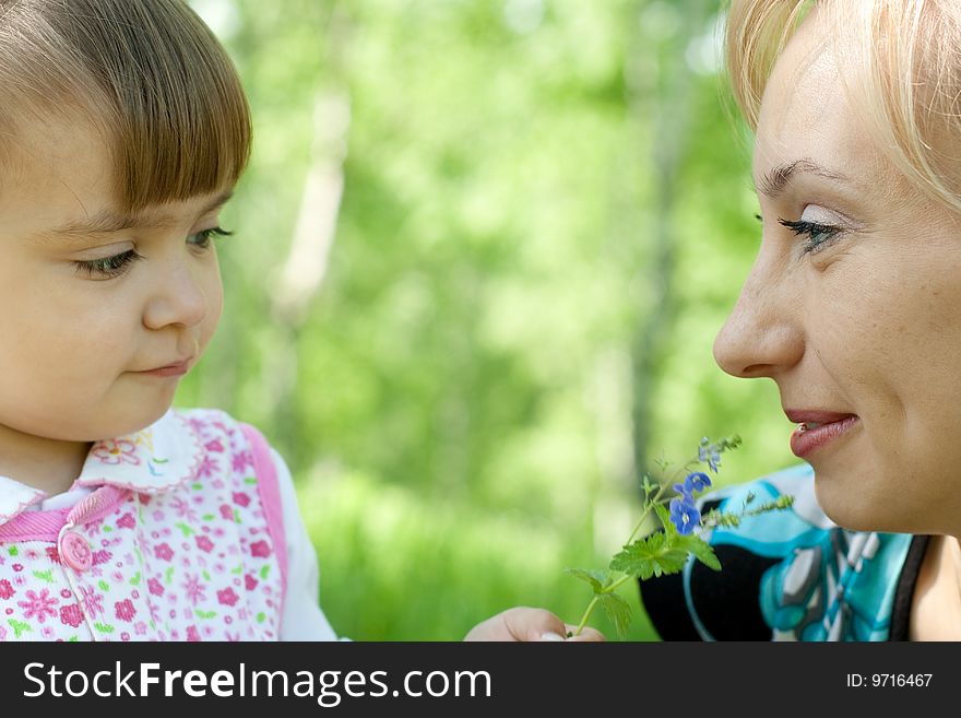 Mother And Daughter With Flower Outdoor In Summer