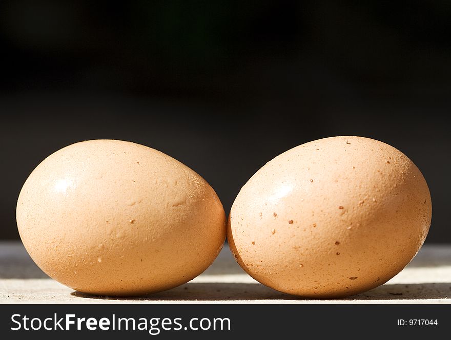 Close up of two eggs on a black background