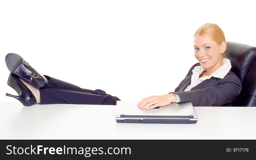 Businesswoman relaxing with legs on table.