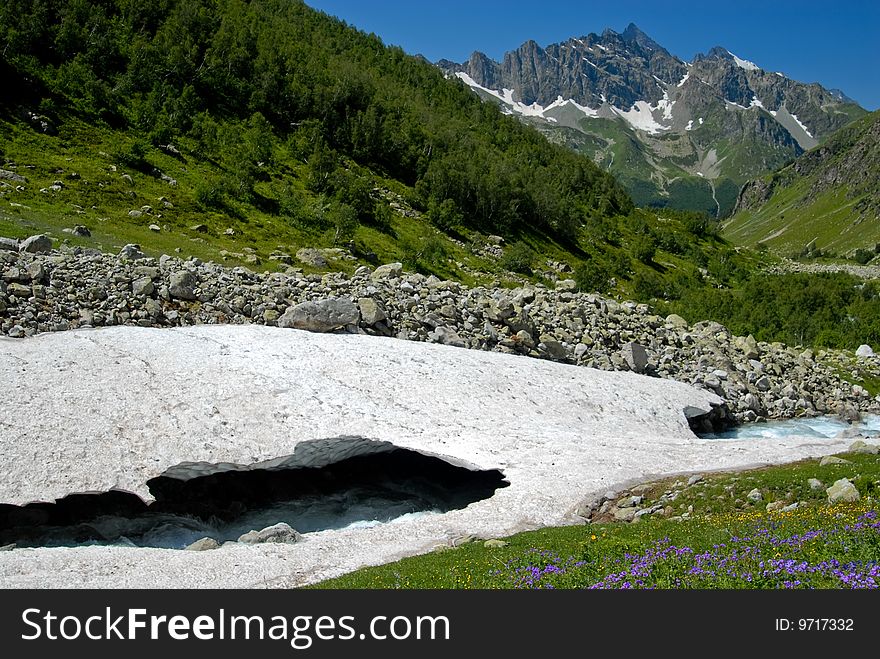 Glacier in the Caucasus, the forests, mountains far. Glacier in the Caucasus, the forests, mountains far