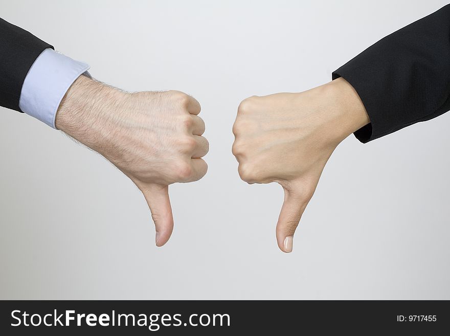 One female hand and one male hand giving their NO. One female hand and one male hand giving their NO