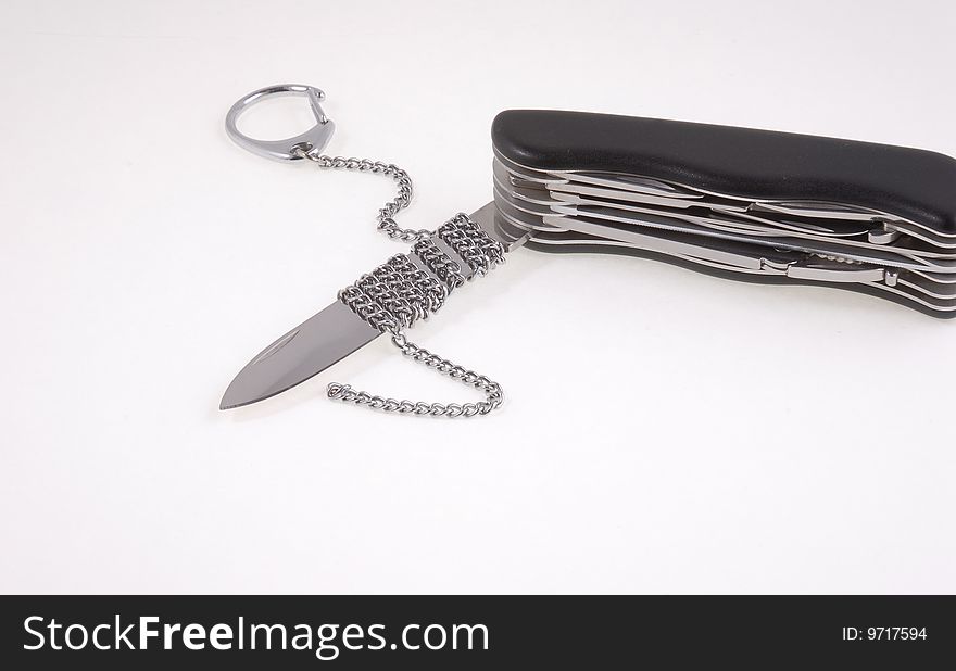 Folding pocket knife with a chain and opened blade. Folding pocket knife with a chain and opened blade