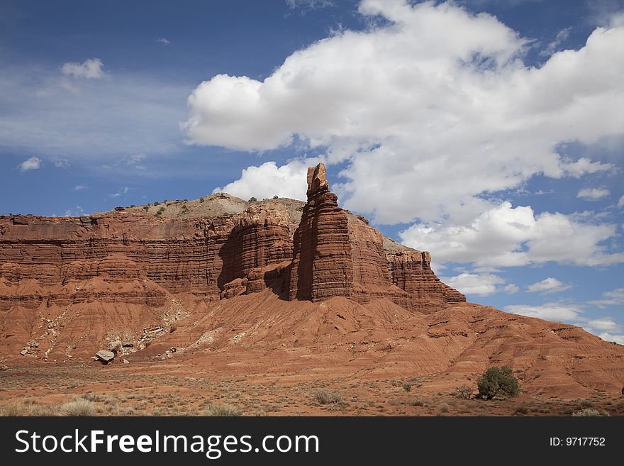 View of red rock formations in Captiol Reef National Park with blue sky�s the and clouds