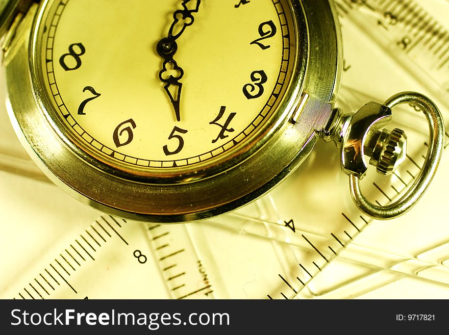 Pocket watch and transparent rulers (symbolizing measurement tools). Pocket watch and transparent rulers (symbolizing measurement tools)