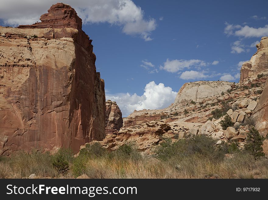 View of red rock formations in Captiol Reef National Park with blue sky�s the and clouds