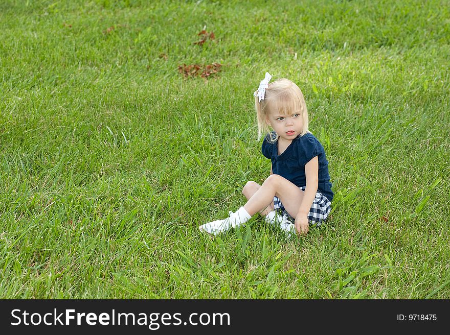 One Girl Sitting In Grass
