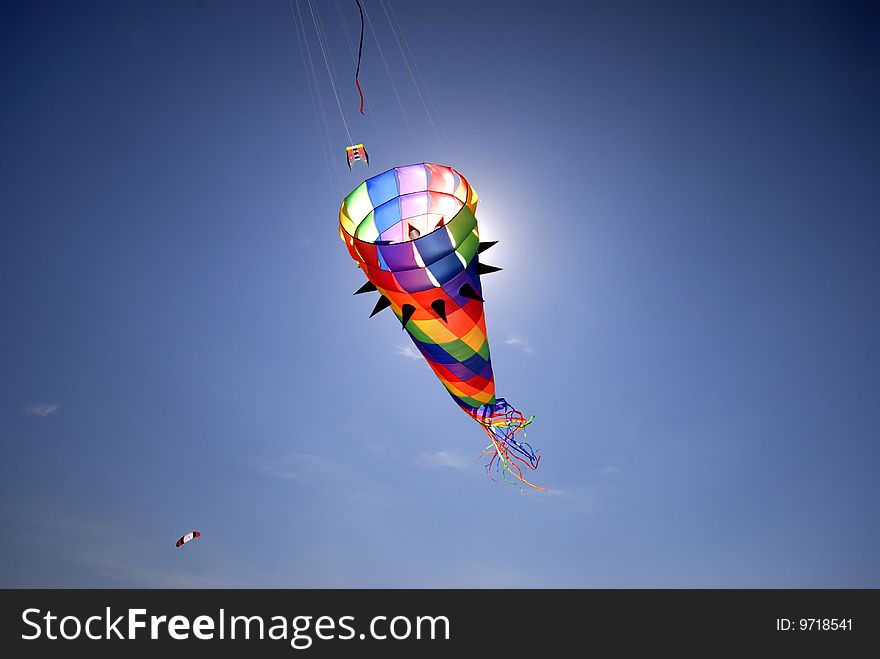 Fantasy kite high-up in the blue sky a sunny day on a Danish beach. Fantasy kite high-up in the blue sky a sunny day on a Danish beach.