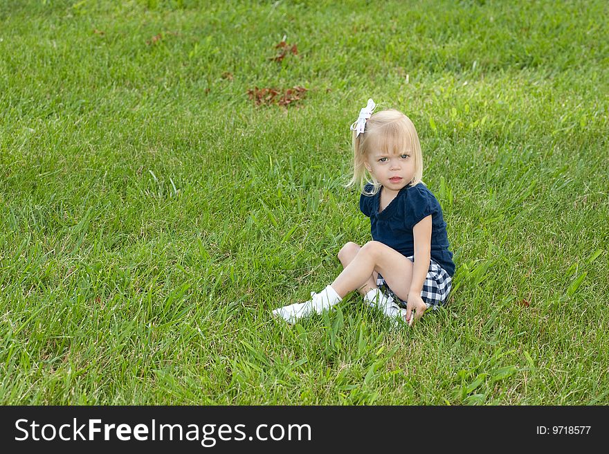 One Girl Sitting In Grass