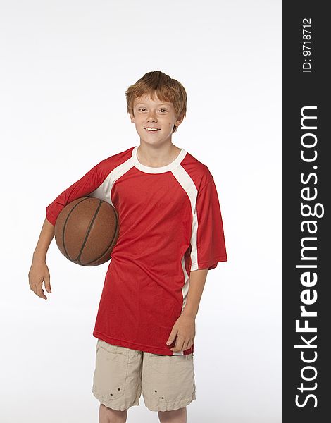 Young man on white holding basketball. Young man on white holding basketball
