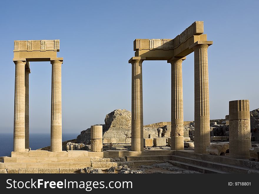 In the city of Lindos on a high rock there are ruins of an ancient acropolis. In this acropolis there was a temple of the ancient Greek goddess of Athena. Island Rhodes. Greece. In the city of Lindos on a high rock there are ruins of an ancient acropolis. In this acropolis there was a temple of the ancient Greek goddess of Athena. Island Rhodes. Greece.