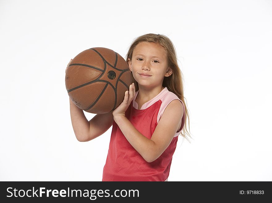 Little girl on white holding a basketball. Little girl on white holding a basketball