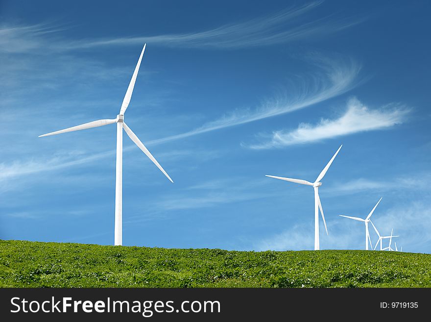 Wind turbines in an open field on cloudy day