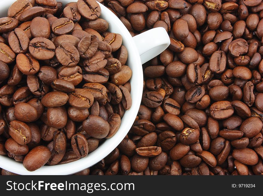 White cup filled with coffee beans