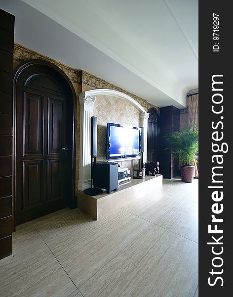 Media center in modern home with arched wooden door. Media center in modern home with arched wooden door.
