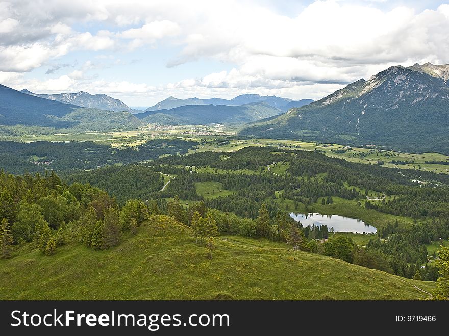 View from the mountain kranzberg near mittenwald, bavaria, to the valley with the mountain-range of karwendel massif in the background. View from the mountain kranzberg near mittenwald, bavaria, to the valley with the mountain-range of karwendel massif in the background