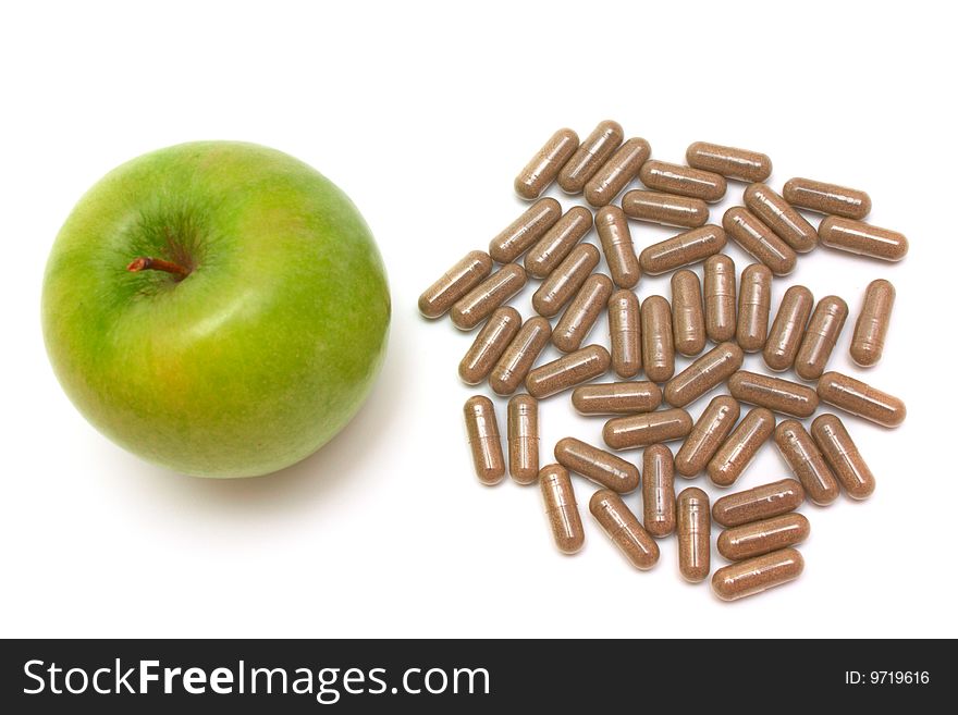 Apple and vitamin capsules on white background. Apple and vitamin capsules on white background