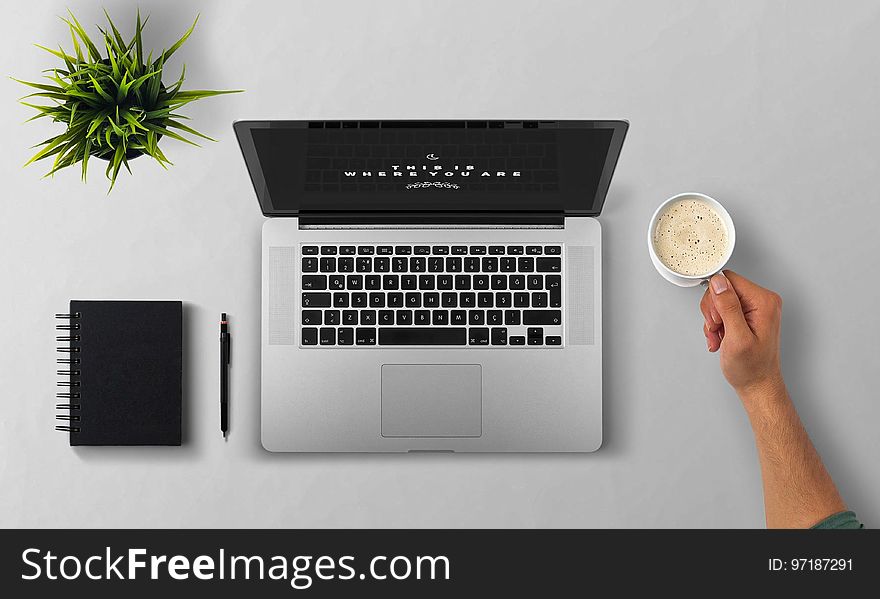 Man Using Laptop on Table Against White Background