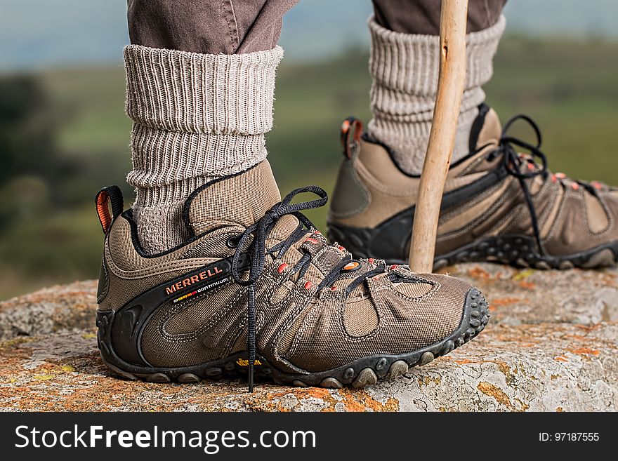 Men&#x27;s Brown and Gray Merrell Hiking Shoes Holding Stick