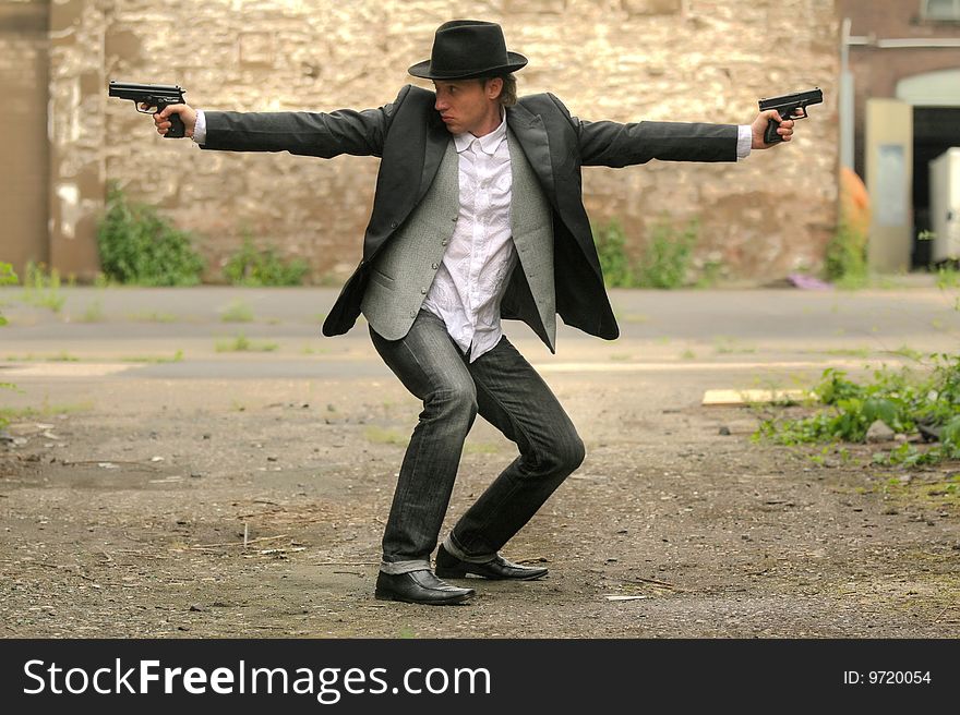 Man with two guns on the street. Man with two guns on the street
