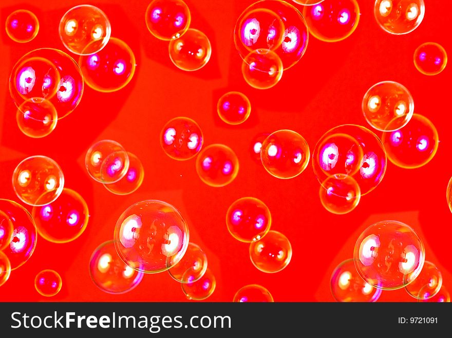 Soap bubbles isolated on red background