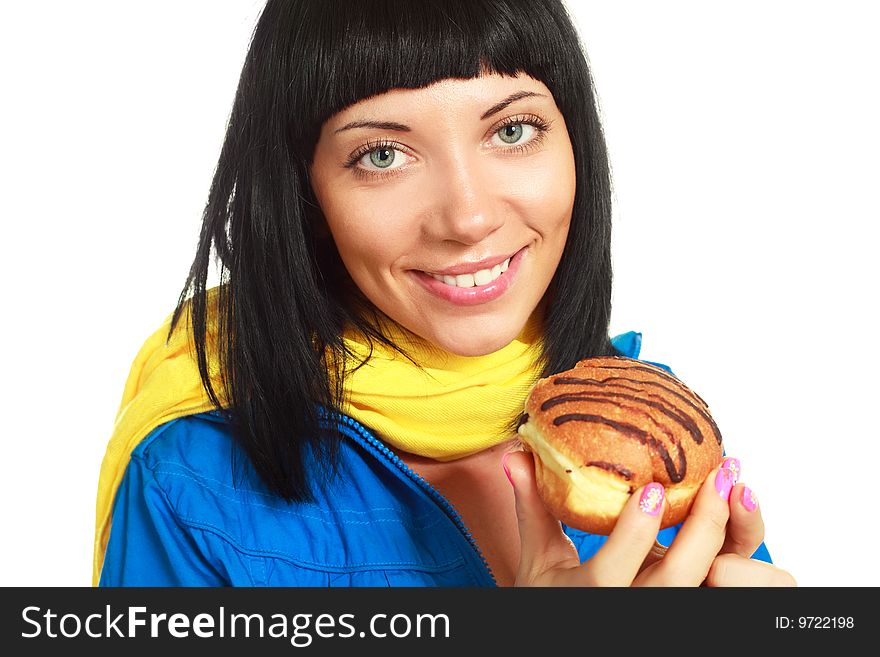 Pretty young brunette woman eating a roll with chocolate. Pretty young brunette woman eating a roll with chocolate