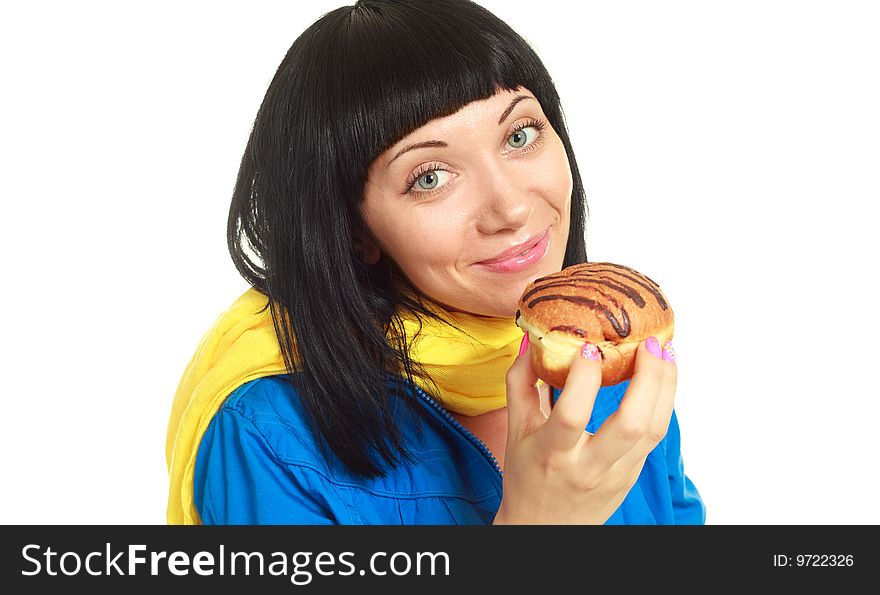 Pretty young brunette woman eating a roll with chocolate. Pretty young brunette woman eating a roll with chocolate