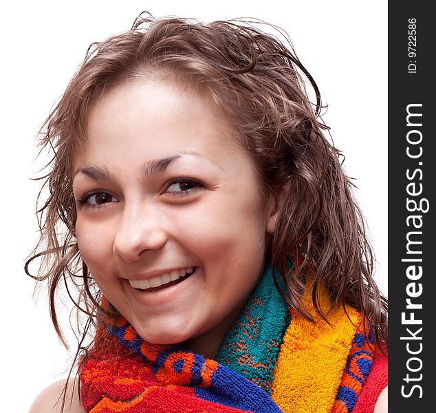 Beautiful girl with wet hair smiles in colour towel, on white background. Beautiful girl with wet hair smiles in colour towel, on white background