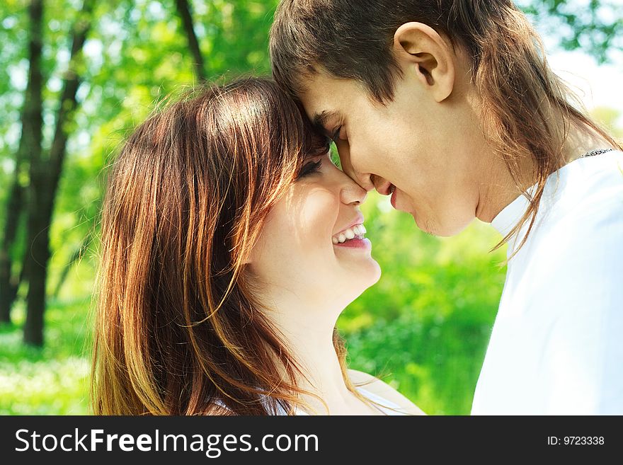 Happy young couple spending time in summer park. Happy young couple spending time in summer park